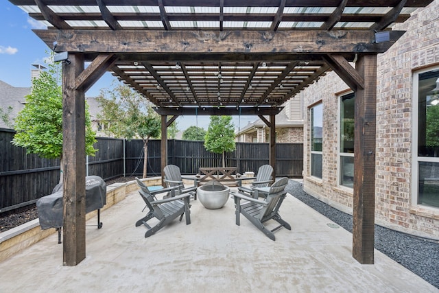 view of patio with a pergola and an outdoor fire pit