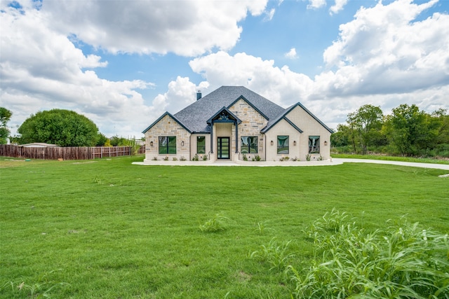 rear view of house featuring a lawn