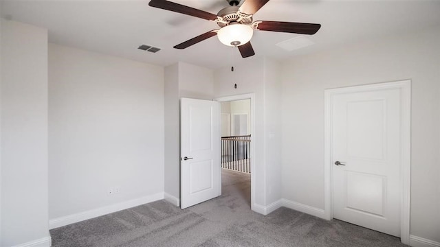 unfurnished bedroom featuring light carpet and ceiling fan