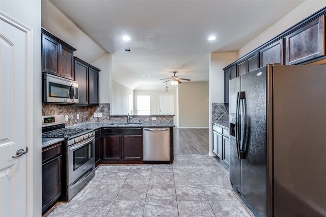 kitchen with dark brown cabinetry, stainless steel appliances, sink, and ceiling fan