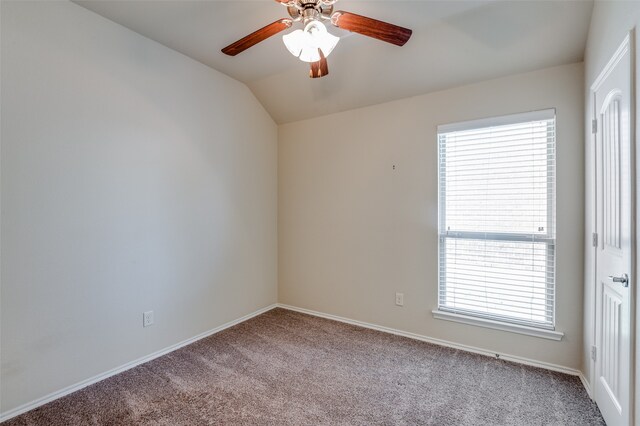 carpeted empty room featuring ceiling fan and vaulted ceiling