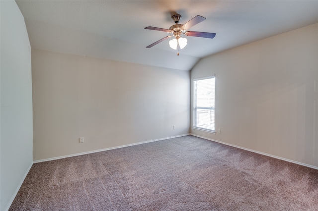 carpeted empty room featuring ceiling fan and vaulted ceiling