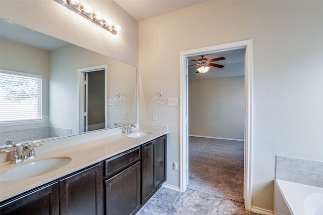 bathroom featuring a bath, ceiling fan, vanity, and tile patterned flooring