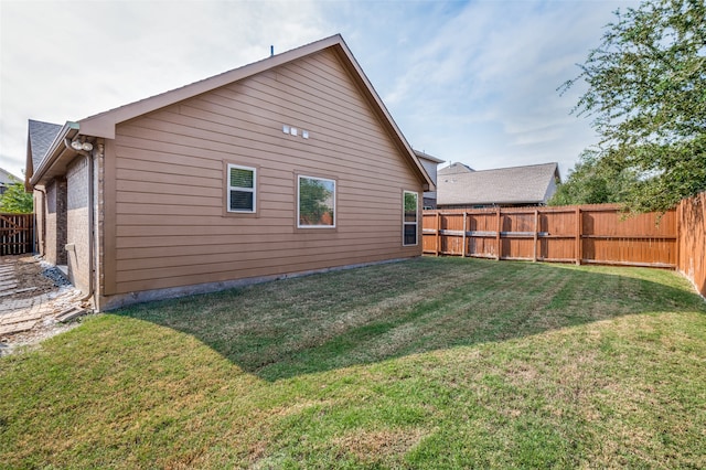 rear view of property with a lawn