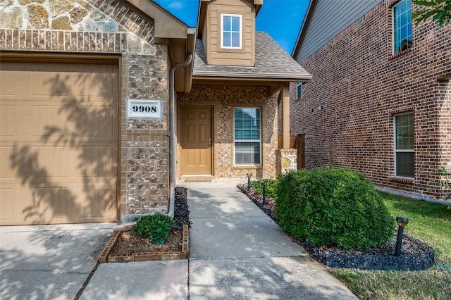 view of exterior entry with a garage