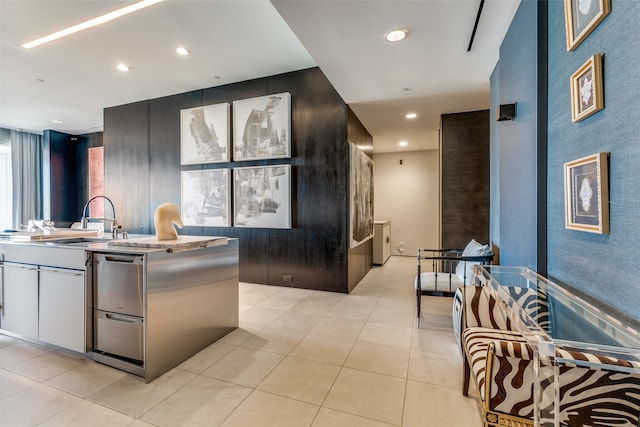 kitchen featuring light tile patterned floors, white cabinetry, and sink