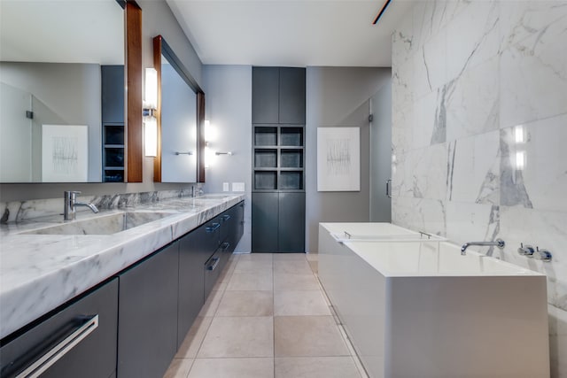 bathroom with vanity, tile patterned floors, and a tub