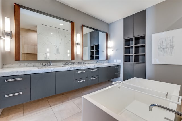 bathroom with vanity, tile patterned floors, and a tub