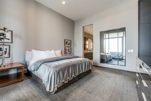 bedroom featuring ensuite bathroom and carpet floors