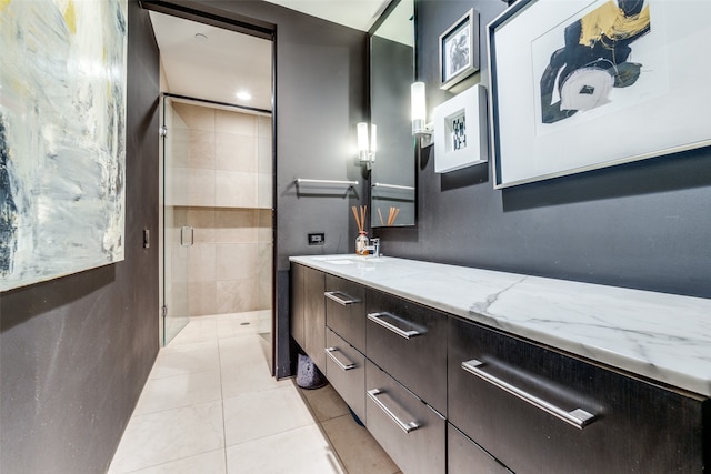 bathroom with vanity, an enclosed shower, and tile patterned floors