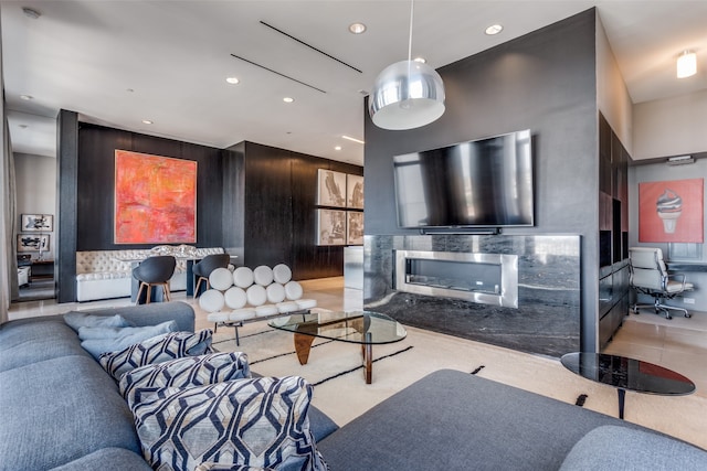 living room featuring light tile patterned flooring and wooden walls