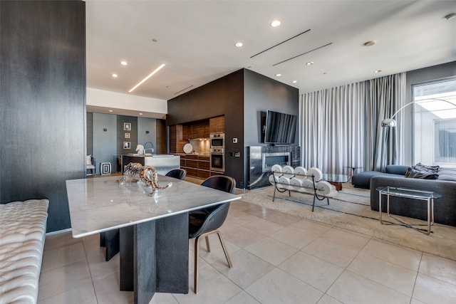 tiled dining area with a fireplace