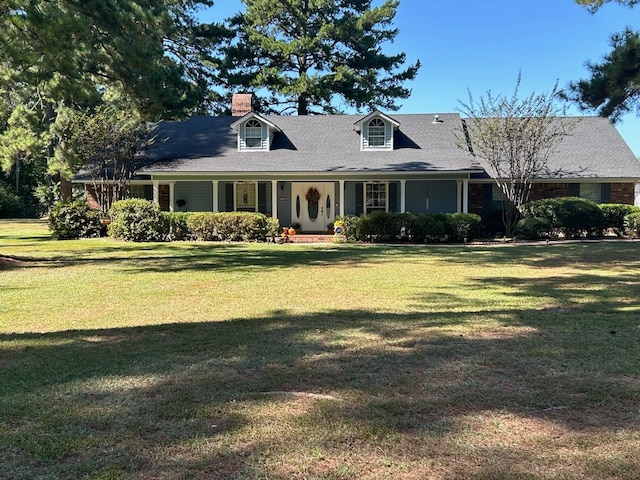 cape cod-style house with covered porch and a front yard