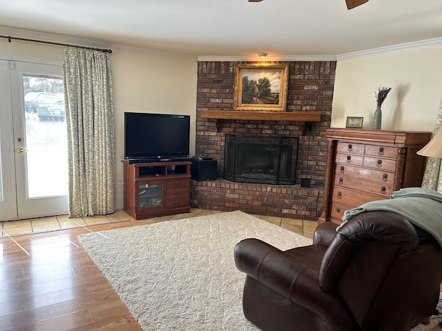 living room with a fireplace, ornamental molding, and light wood-type flooring