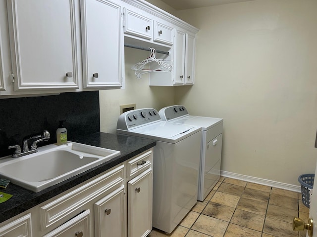 laundry area with cabinets, sink, and washing machine and clothes dryer