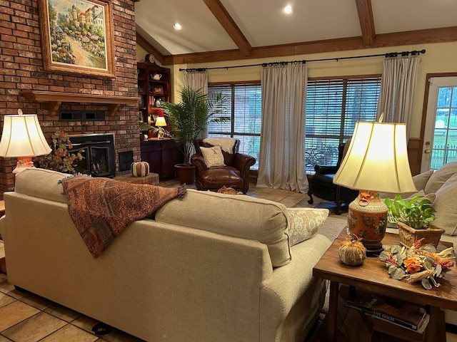 living room featuring light tile patterned flooring, plenty of natural light, lofted ceiling with beams, and a brick fireplace