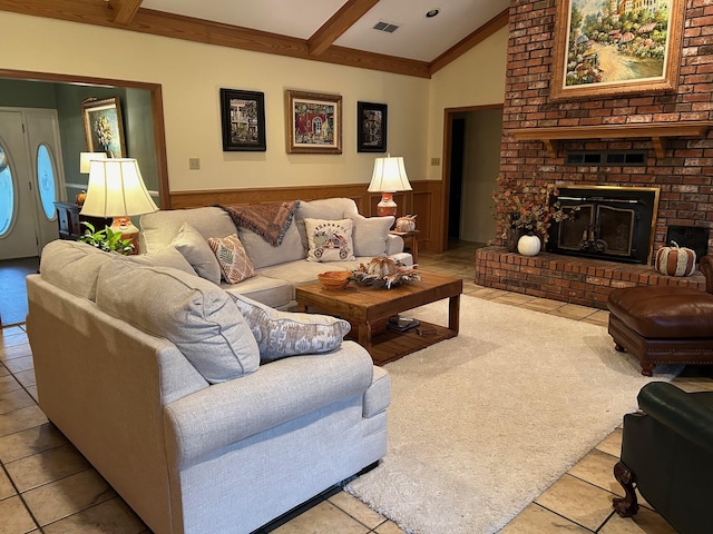 living room with lofted ceiling with beams and a brick fireplace