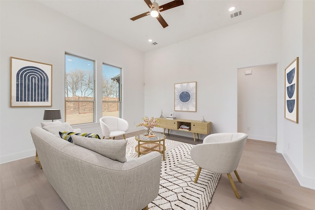 living room featuring light hardwood / wood-style floors and ceiling fan