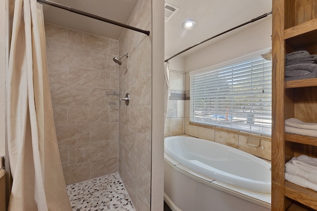 bathroom featuring curtained shower and a textured ceiling