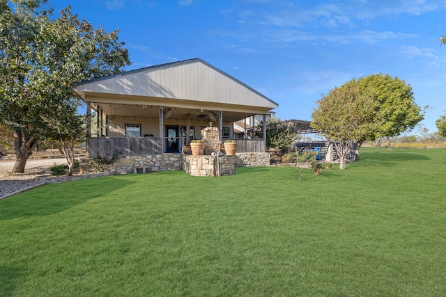 exterior space featuring ceiling fan and a yard