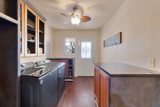 laundry room with dark wood-type flooring, cabinets, a textured ceiling, washer and clothes dryer, and ceiling fan