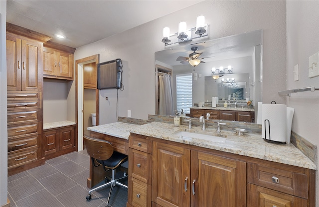 bathroom featuring vanity, ceiling fan, and toilet