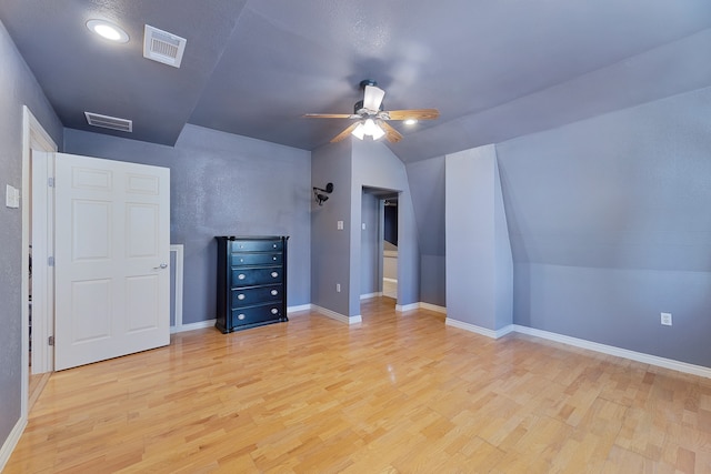 additional living space with ceiling fan, vaulted ceiling, and light hardwood / wood-style floors