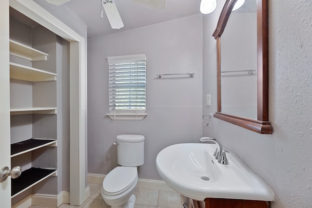 bathroom with toilet, sink, tile patterned flooring, and ceiling fan