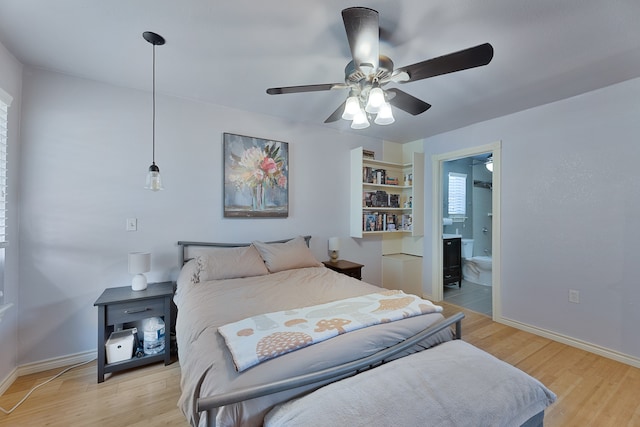 bedroom with light hardwood / wood-style floors, ceiling fan, and ensuite bathroom