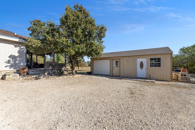 exterior space featuring an outbuilding and a garage