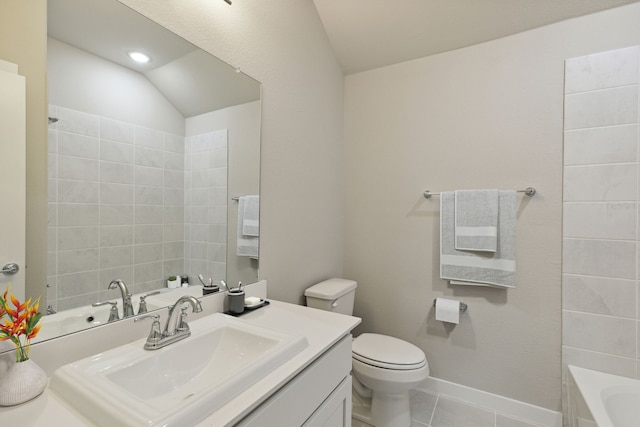 bathroom featuring tile patterned flooring, vanity, toilet, and vaulted ceiling