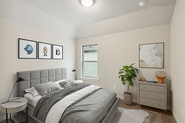 carpeted bedroom with vaulted ceiling