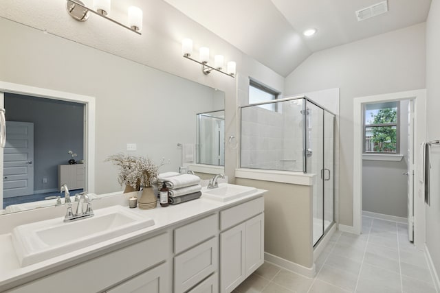 bathroom with vanity, an enclosed shower, vaulted ceiling, and tile patterned floors