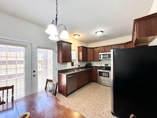 kitchen with dark brown cabinetry, appliances with stainless steel finishes, decorative light fixtures, a chandelier, and french doors