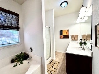 bathroom featuring vanity and shower with separate bathtub