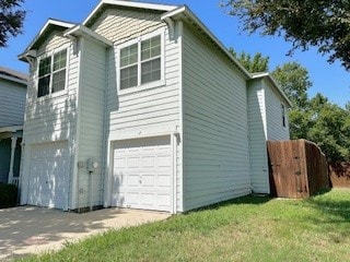 view of property exterior with a garage and a lawn