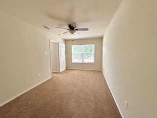 empty room featuring light carpet and ceiling fan