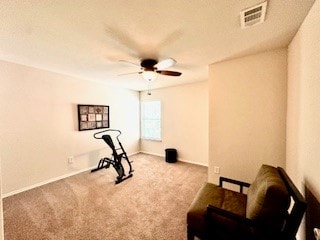 workout room with light carpet and ceiling fan