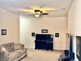 carpeted living room featuring ceiling fan