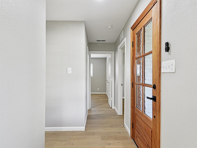 hall with light hardwood / wood-style flooring