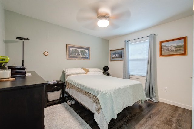 bedroom with dark hardwood / wood-style floors and ceiling fan