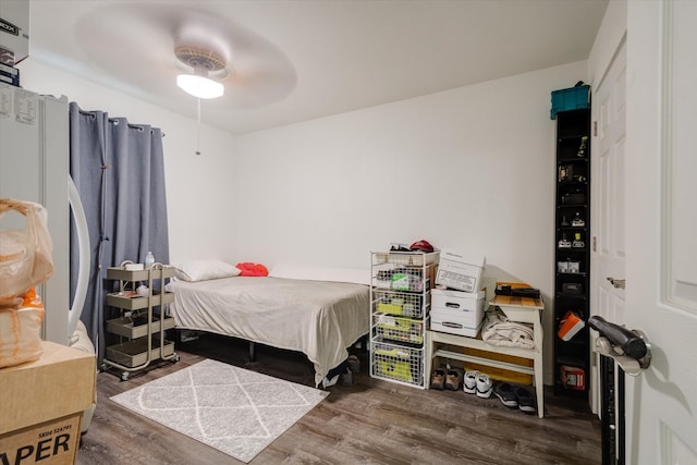 bedroom with ceiling fan and dark hardwood / wood-style flooring