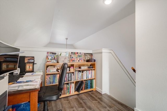 home office with dark wood-type flooring and lofted ceiling