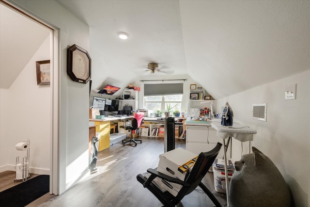 office area with wood-type flooring, ceiling fan, built in desk, and vaulted ceiling