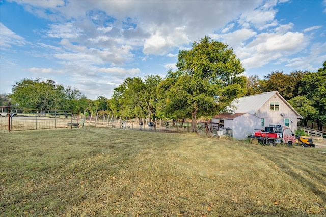 view of yard featuring an outdoor structure and a rural view