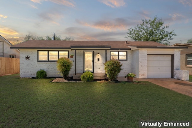 ranch-style house featuring a lawn and a garage