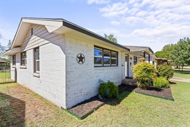 view of property exterior with a yard