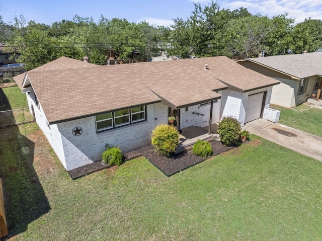 ranch-style house featuring a garage and a front yard