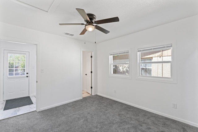 empty room featuring carpet flooring and ceiling fan