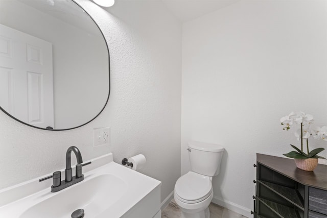 bathroom featuring toilet and vanity